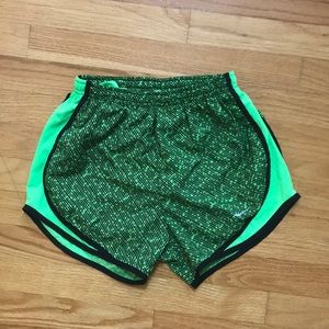 Women’s green and black patterned Nike shorts.